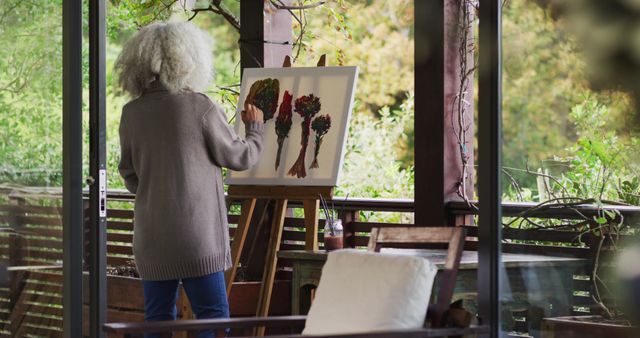 Senior Woman Painting Botanicals On Enclosed Porch - Download Free Stock Images Pikwizard.com