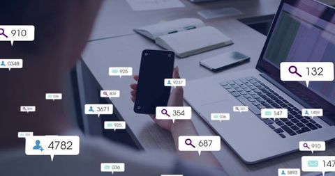 Woman holding smartphone checking notifications at laptop with floating analytics badges