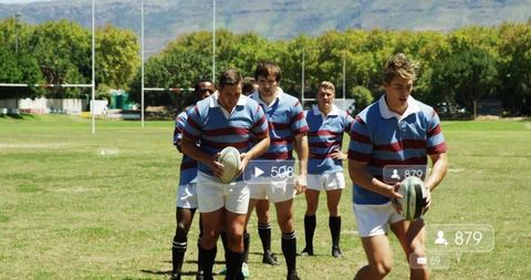 Rugby players moving into formation during team training on sunny grass pitch