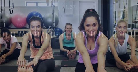 Diverse group of women stretching in gym meditation studio