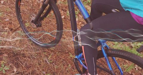 Cyclist navigating forest trail with waveform overlay