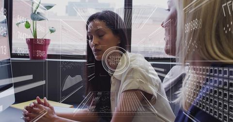 Women Collaborating on Data Analytics at Office Desk