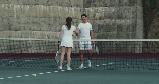 Man and Woman Shaking Hands on Tennis Court After Match - Download Free Stock Images Pikwizard.com