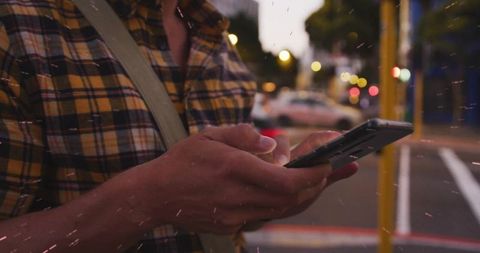 Urban Man Using Smartphone in Evening Cityscape
