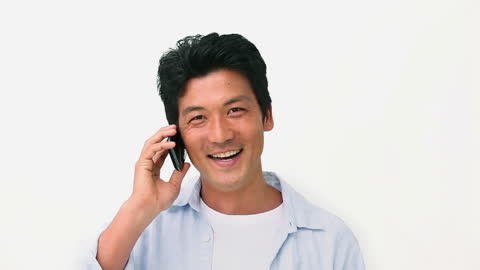 Happy Man Talking on Smartphone Indoors