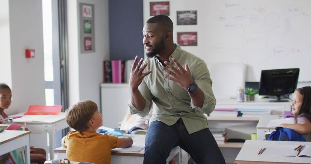 Image of happy african american male teacher during lesson with class of diverse pupils - Download Free Stock Photos Pikwizard.com