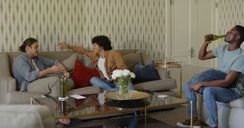 Friends Socializing on Comfortable Sofa