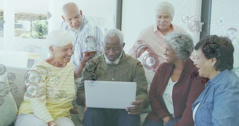 Senior Group Engaged with Technology in Cozy Living Room