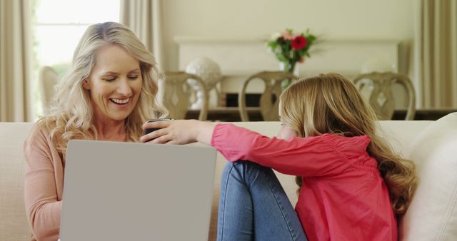 Smiling Mother and Daughter Enjoying Time Together on Living Room Sofa - Download Free Stock Images Pikwizard.com