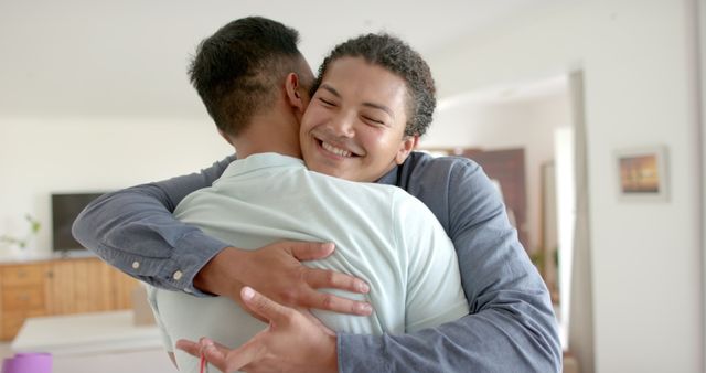 Happy Friends Embracing with Joyful Expressions Indoors - Download Free Stock Images Pikwizard.com