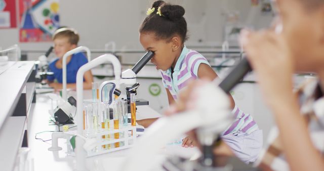 Image of happy african american girl with microscope during lesson - Download Free Stock Photos Pikwizard.com