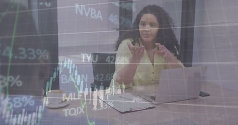Businesswoman Analyzing Financial Charts in Office