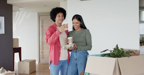 Smiling Couple with Coffee during Moving Day