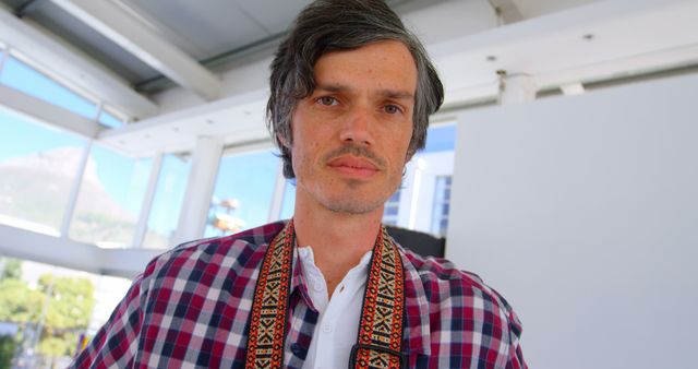 Confident Middle-aged Man in Checkered Shirt and Traditional Scarf Indoors - Download Free Stock Images Pikwizard.com