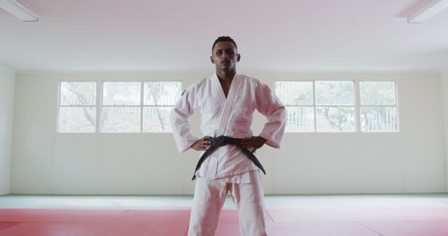 Confident Male Martial Artist in Judo Gi Standing in Training Dojo - Download Free Stock Images Pikwizard.com