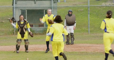 Female softball team celebrating victory on field