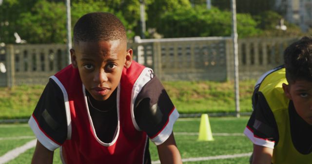 Young Boys Practicing Football on Field with Determined Expressions - Download Free Stock Images Pikwizard.com