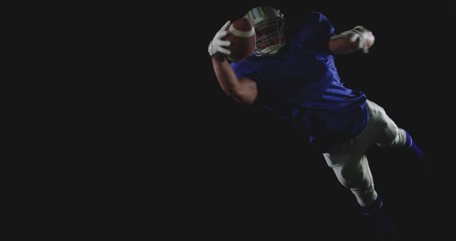 Football Player Catching Ball Mid-Air on Black Background - Download Free Stock Images Pikwizard.com