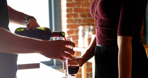 Couple Pouring Red Wine in Cozy Home Atmosphere - Download Free Stock Images Pikwizard.com