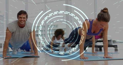 Adults holding plank position in group fitness class with futuristic hud overlay