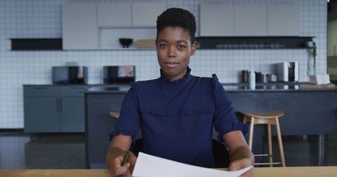 Businesswoman Conducting Virtual Meeting in Office Kitchen