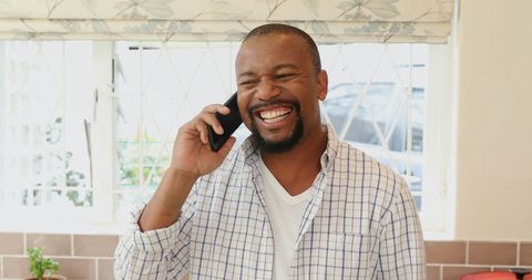 Happy Man Talking on Phone in Bright Kitchen Setting - Download Free Stock Images Pikwizard.com