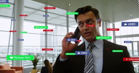 Businessman talking on phone with social media notifications floating in office atrium