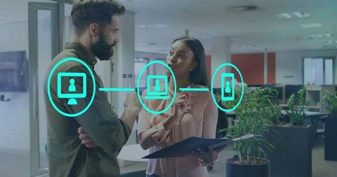 Colleagues Discussing Digital Networking Workflow with UI Icons in Modern Open Office