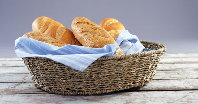 Freshly Baked Bread in Wicker Basket on Wooden Table - Download Free Stock Images Pikwizard.com