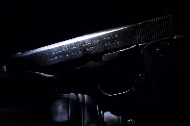 Close-Up of Handgun in Low Light - Download Free Stock Photos Pikwizard.com