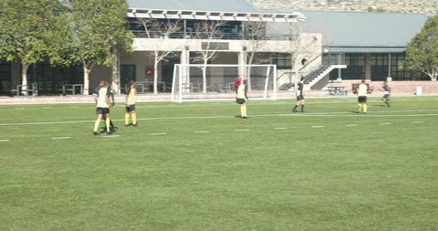 Soccer Players Practicing Coordination and Team Strategy on Field
