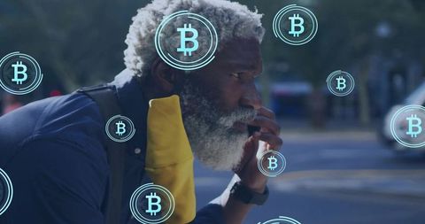 Senior man leaning on curb talking on phone contemplating cryptocurrency with bitcoin icons