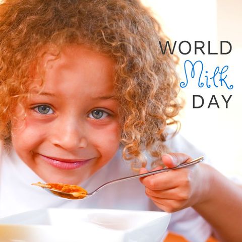 Smiling child enjoying breakfast for world milk day event