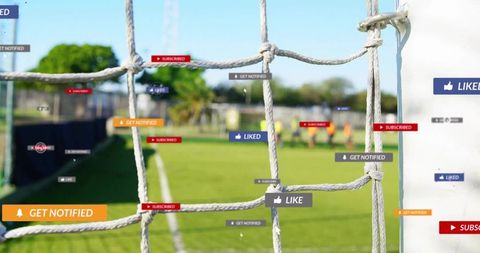 Soccer goal net framing social media notifications over local youth team training session