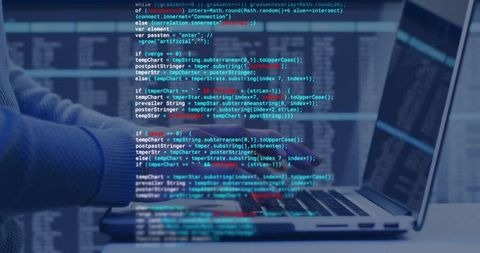 Male developer typing code on laptop keyboard with monitor in minimalist home office