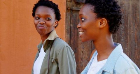 African American Twin Sisters Walking and Interacting in Urban Environment