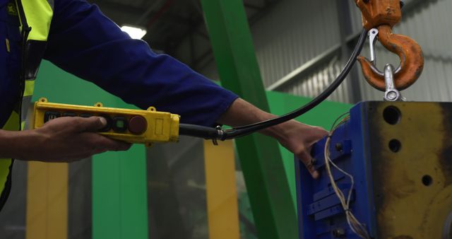 Worker Operating Machinery with Remote Control in Industrial Warehouse - Download Free Stock Images Pikwizard.com