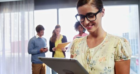 Professional Woman Utilizing Tablet Technology in Office Setting