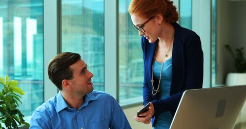 Professional Discussion between Colleagues at Office Desk - Download Free Stock Images Pikwizard.com