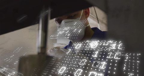 Technician with mask operating machine and binary code overlay