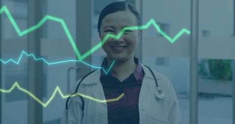 Confident Doctor Smiling in Clinic with Data Visualization