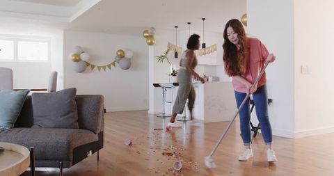 Couple Cleaning House After Party Celebration