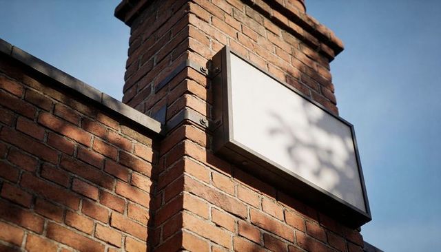 Blank Lightbox Sign Featuring Brick Corner Pillar Casting Foliage Shadows for Mockup