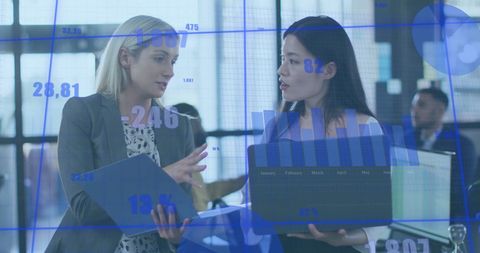 Business Partners Analyzing Financial Data in Modern Office