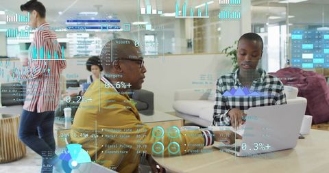 Diverse business team analyzing financial data with digital graphics