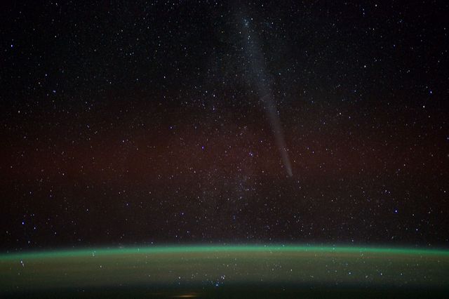 This illuminating photograph captures Comet Lovejoy above Earth as seen from the International Space Station in 2011. The image, marked with enchanting night sky and celestial stars, can be effectively used in the context of astronomy, space exploration, and celestial wonders. Perfect for educational materials, astronomical presentations, and space-themed decor.