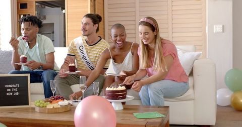 Diverse Friends Celebrating Success with Cake and Drinks at Home