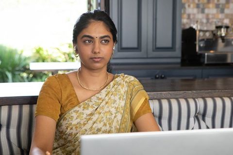 Professional indian woman working on laptop in trendy cafe
