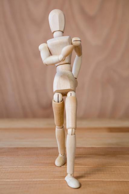 Conceptual image of figurine walking on a wooden floor
