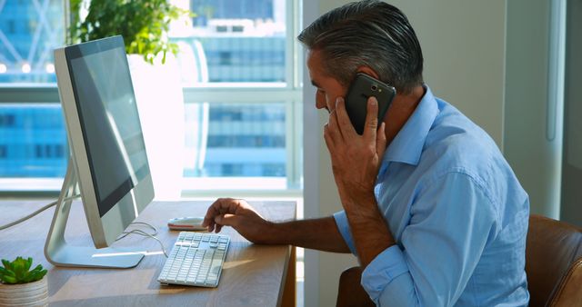 Businessman Working in Modern Office with Computer and Phone - Download Free Stock Images Pikwizard.com